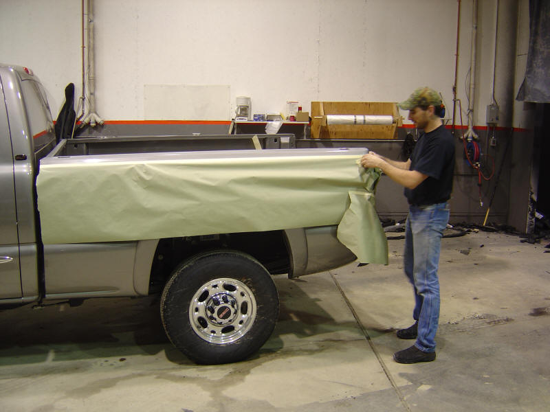 Preparation is one of the key elements to making a good bed liner or coating. We train our dealers so they will have all the skills necessary to give you the best looking and most durable product available. In the above photo the truck has already been cleaned with acetone to remove any waxes or contamination that might be on the surface. The masking process begins. They will mask any area not to be coated, this will eliminate any possibility of over spray problems. The masking process also determines where the finished edges of the bed liner will be located. The cleaner the masking job the nicer the edges will be. So most guys take a little extra time to make sure everything lines up and is in its proper place.